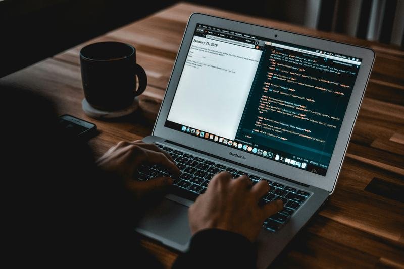 Developer building the BookFast online booking system on a MacBook